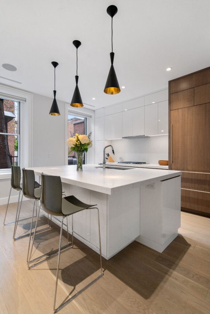 Hancock street Kitchen with fridge; Renovated kitchen at 47 Hancock Street, designed by ArnoldAnd to balance historic brownstone charm with modern functionality. Custom millwork and built-in storage solutions at 47 Hancock Street by ArnoldAnd. Reconfigured floor plan enhancing flow and functionality in this Boston brownstone renovation by ArnoldAnd.