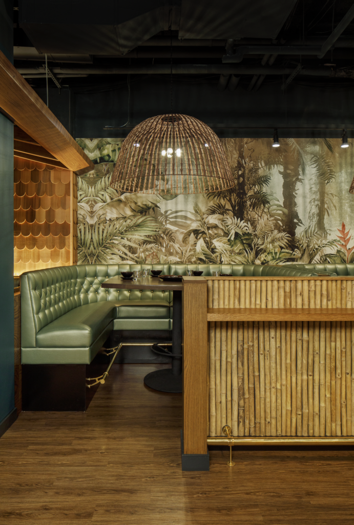Shore Leave, a Boston hospitality project designed by Matthew Arnold, featuring tropical-inspired interiors. Cozy alcove booth seating with ambient lighting at Shore Leave, designed to enhance guest experience.